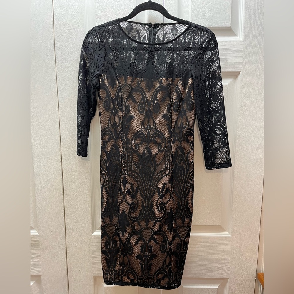 Beige lining straight stress with lace cutout sleeves.